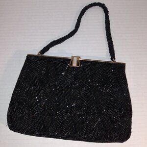 Vintage beaded hand purse with mother of pearl jewel look closure.